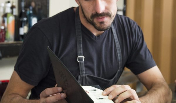 barman-showing-menu-female-customer-bar-counter barman-showing-menu-female-customer-bar-counter